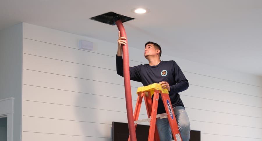 Watts HVAC tech cleaning air ducts.