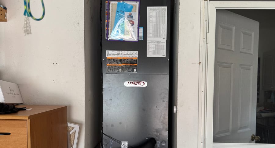 Heating unit installed in wall in garage.