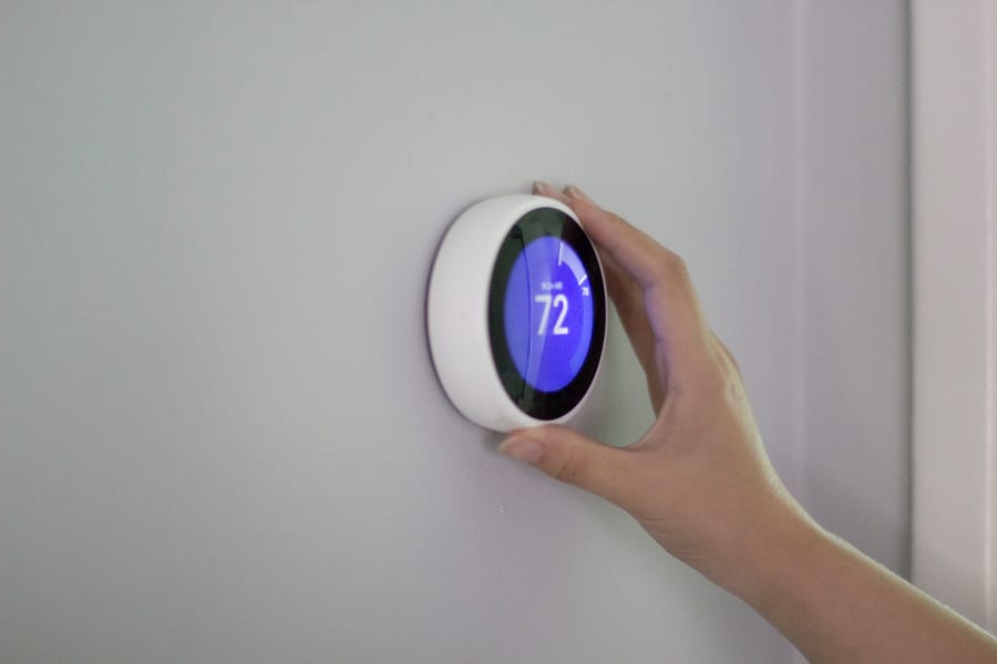 A smart home thermostat on a wall.