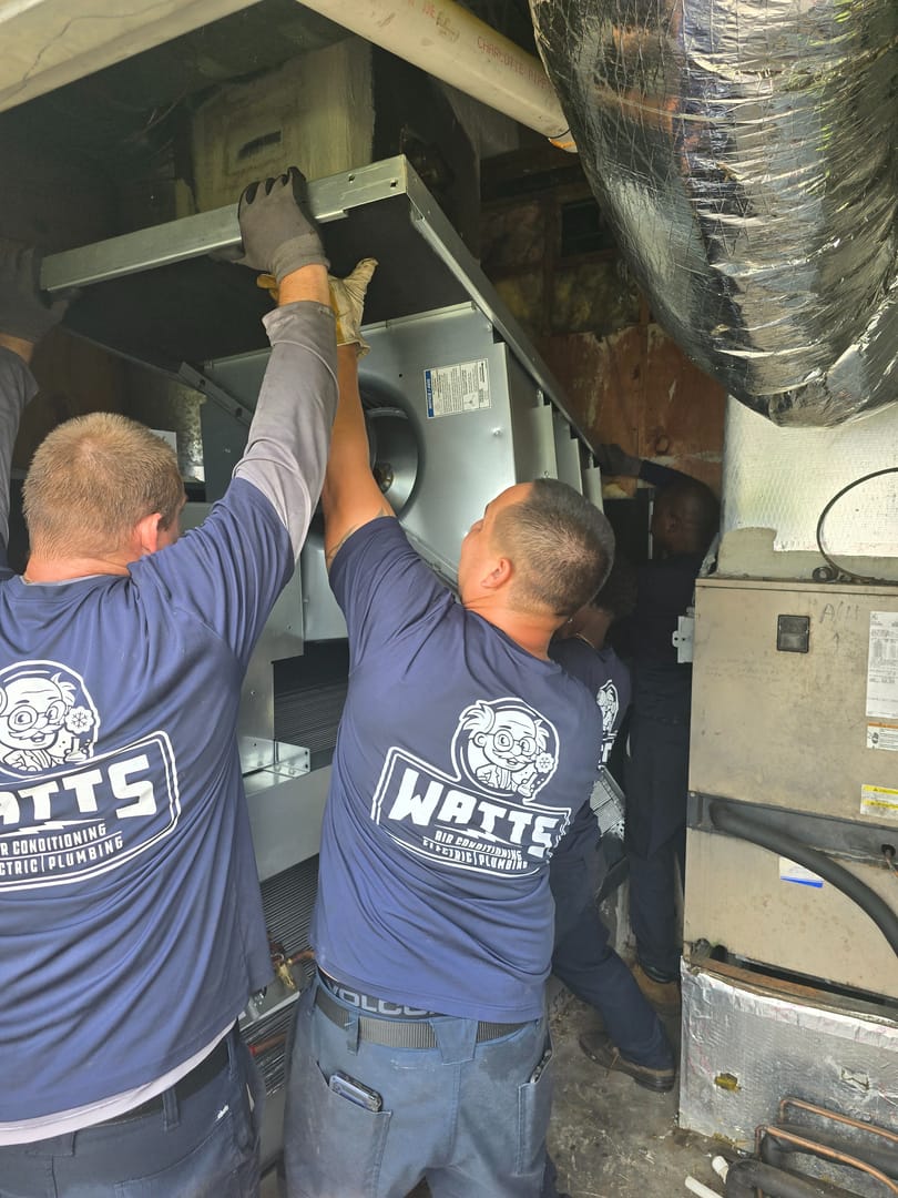 Watts HVAC techs repairing furnace.