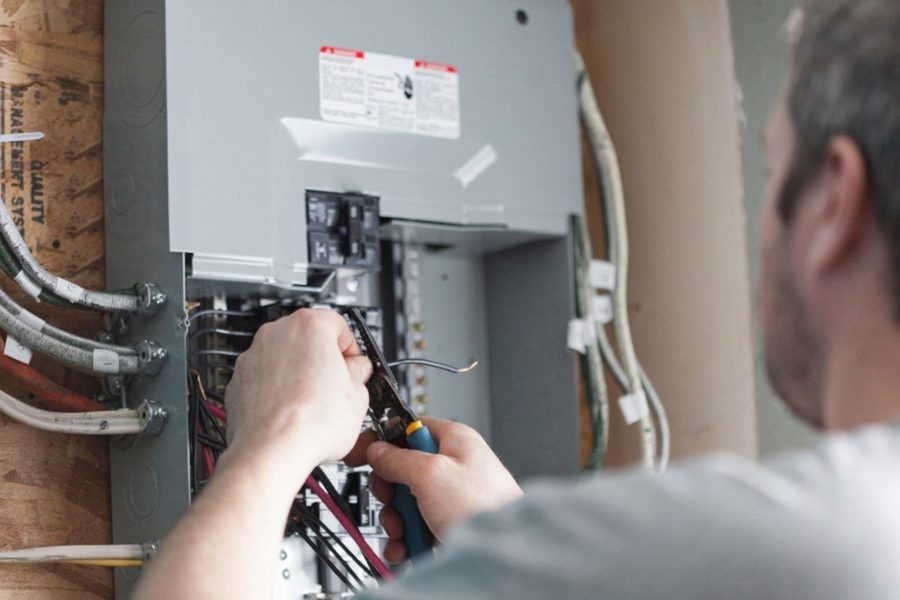 Electrician replacing the distribution board to upgrade a homes electrical panel