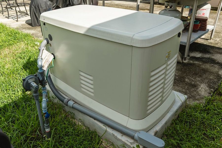 newly installed generator sitting in the grass of someone's backyard