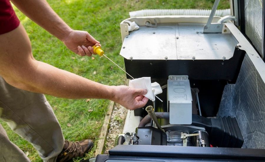 technician checking the oil of a home generator