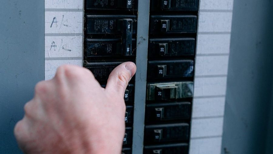 Flipping the breaker on an electrical panel